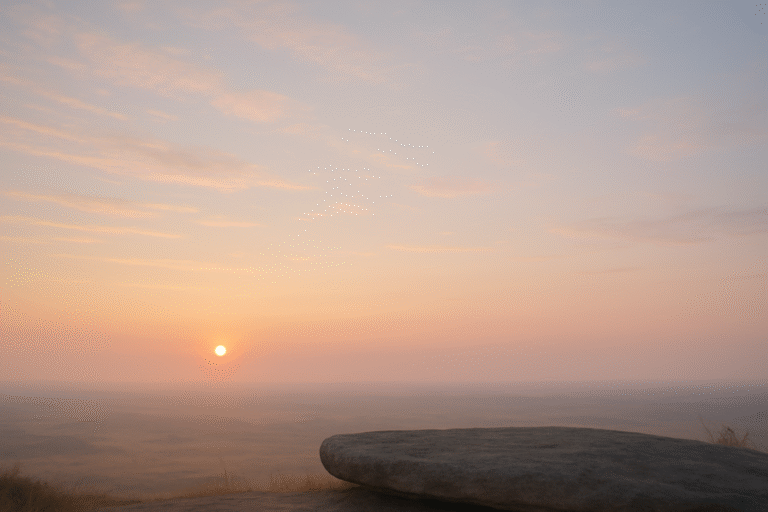 A peaceful figure sitting on a rock at sunrise, looking out over an open sky, symbolizing mental spaciousness and clarity.
